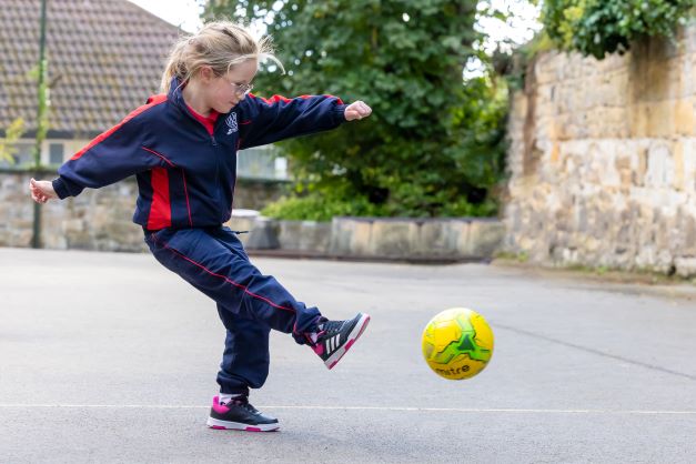 kicking a football